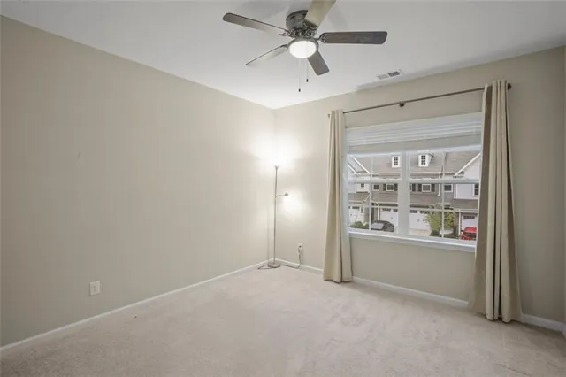 an empty room with windows and closet