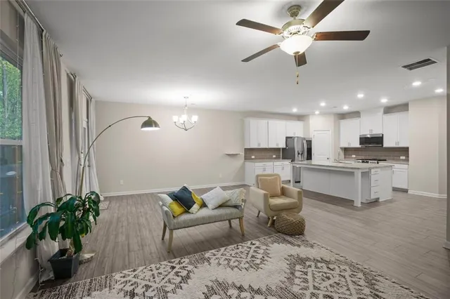 a living room with furniture and kitchen view