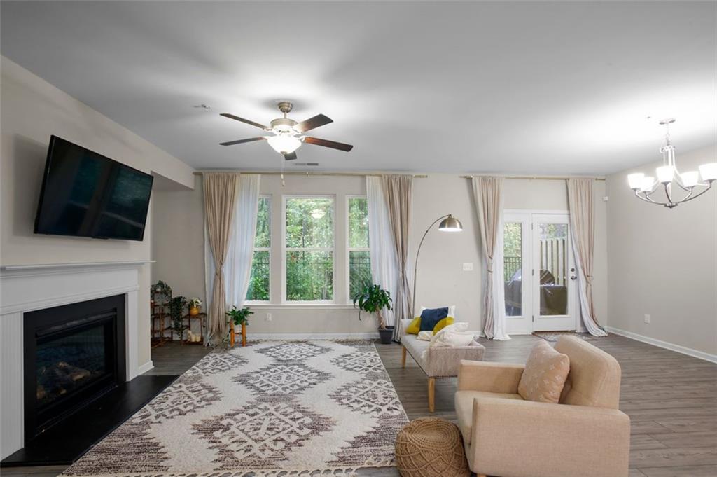 465 Duval Drive Alpharetta, GA 30009 - Photo 4 of 21 a living room with furniture a fireplace and a flat screen tv