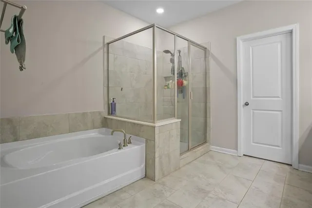 a bathroom with a bathtub and a shower