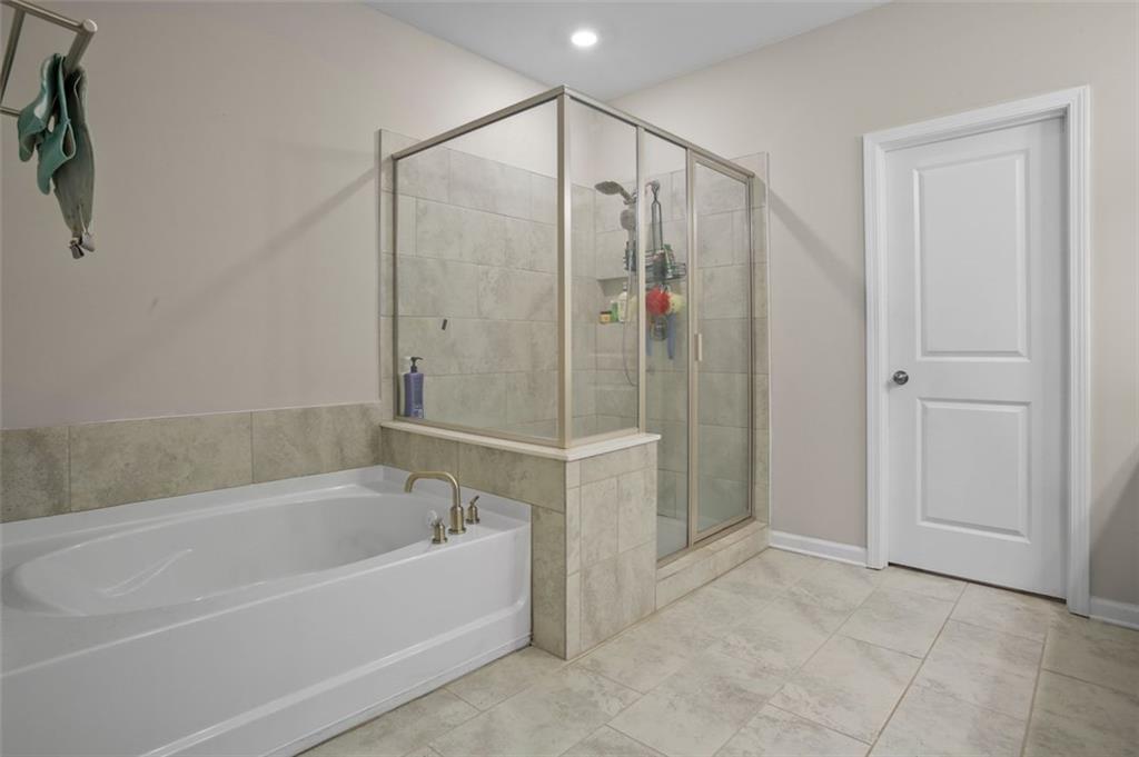 465 Duval Drive Alpharetta, GA 30009 - Photo 8 of 21 a bathroom with a bathtub and a shower