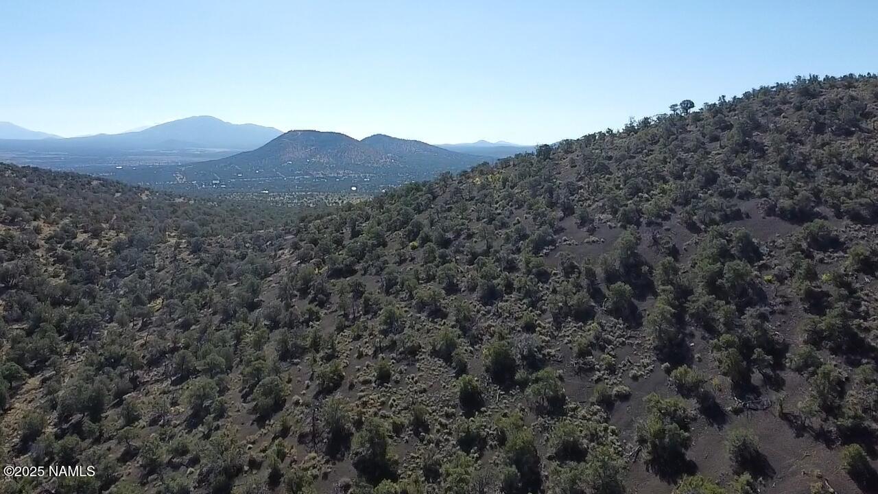 a view of a large mountain with a mountain in the background