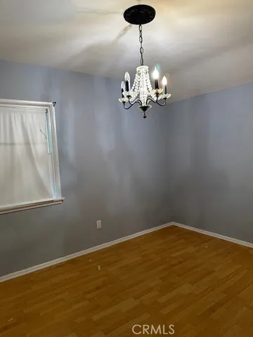 a view of room with window and chandelier