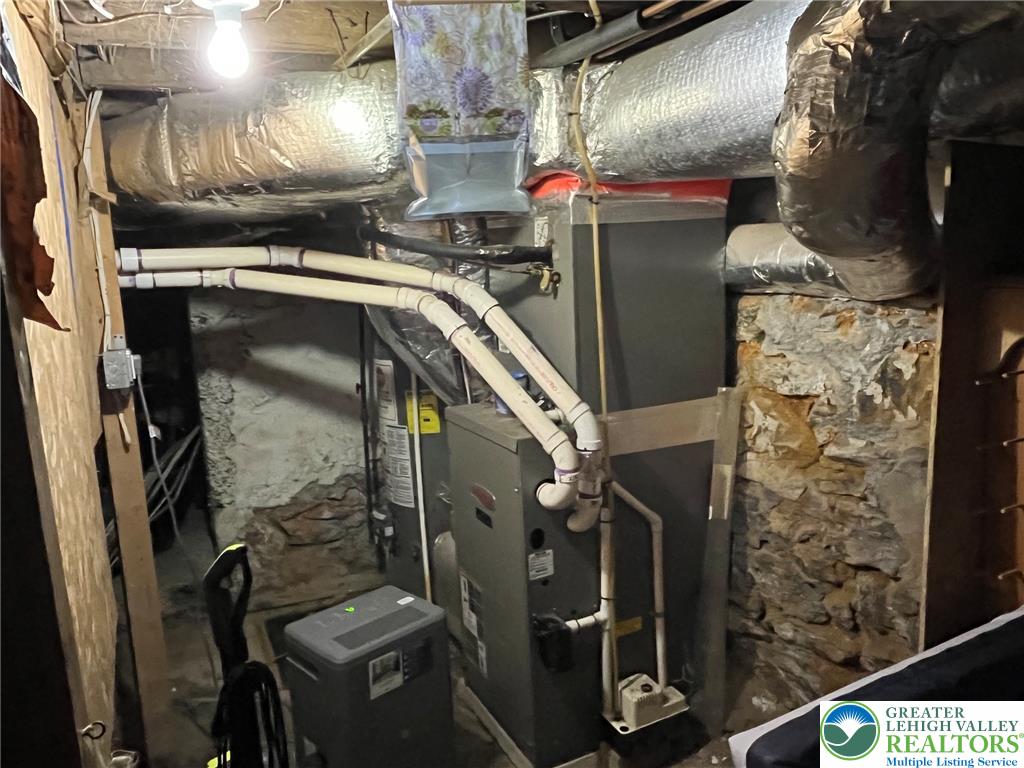 765 3rd Street Whitehall, PA 18052 - Photo 29 of 30 Essential utilities and foundational elements within a utilitarian basement space.