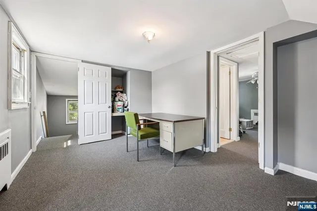 a view of a livingroom with furniture and a hallway