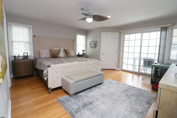 a bedroom with a bed and glass walk in closet