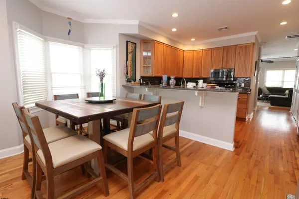 a view of backyard with seating space and trees in the background