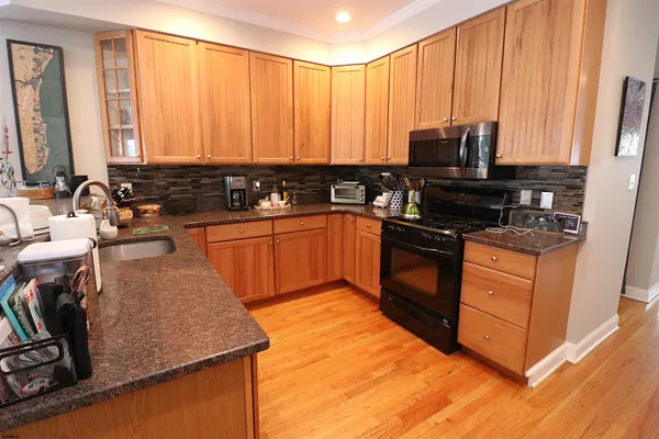 a kitchen with a sink stove and microwave