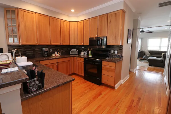 a kitchen with wooden cabinets and a sink