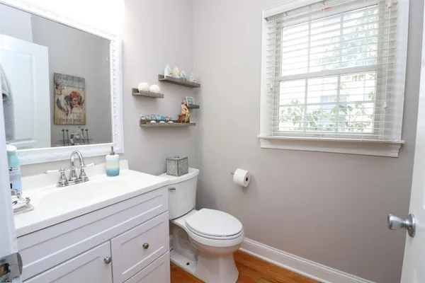 a bathroom with a sink a toilet and a window