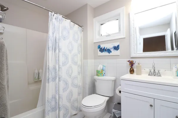 a bathroom with a granite countertop toilet a sink a vanity and a shower