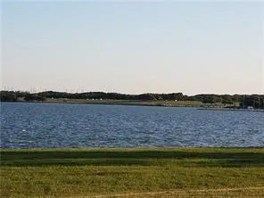 a view of a lake with houses in the background