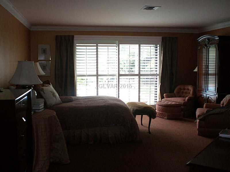 1485 Westwind Road Las Vegas, NV 89146 - Photo 6 of 13 Master Bedroom. Master bedroom with sliding door to pool. This cozy retreat also features a fireplace