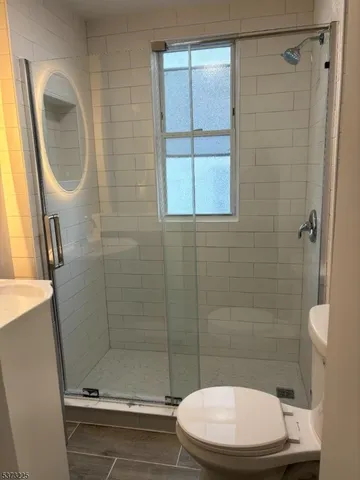 a bathroom with a toilet and a shower