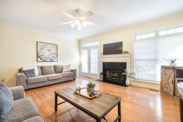a living room with furniture a fireplace and a flat screen tv