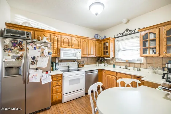 a kitchen with stainless steel appliances a sink a stove and a refrigerator