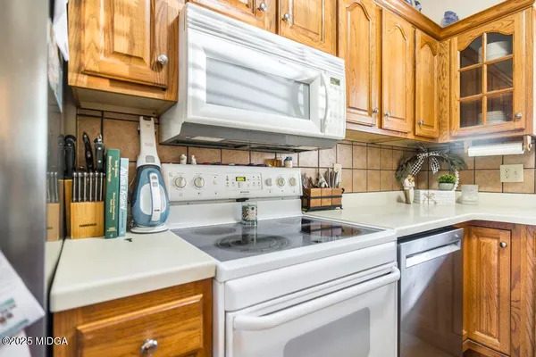 a kitchen with a sink and a stove next to a window