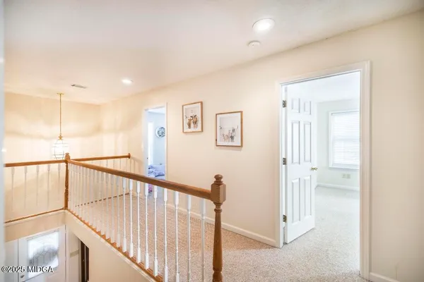 a view of a hallway with staircase
