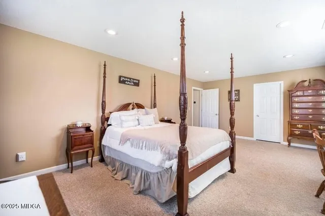 a bed room with a bed and a chair