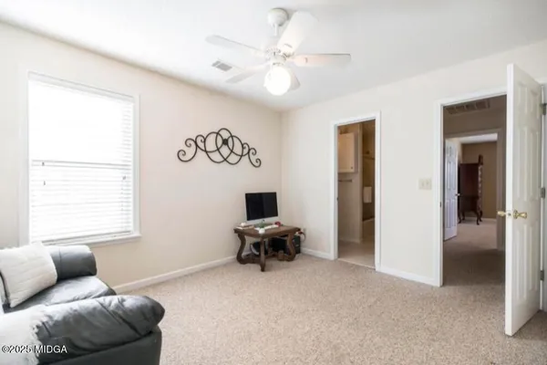 a living room with furniture and white walls