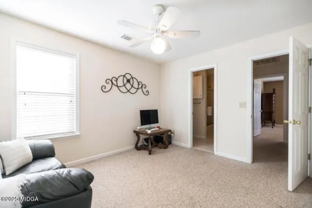 a living room with furniture and white walls