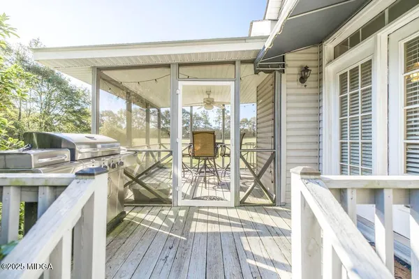 a view of a balcony with wooden floor and furniture