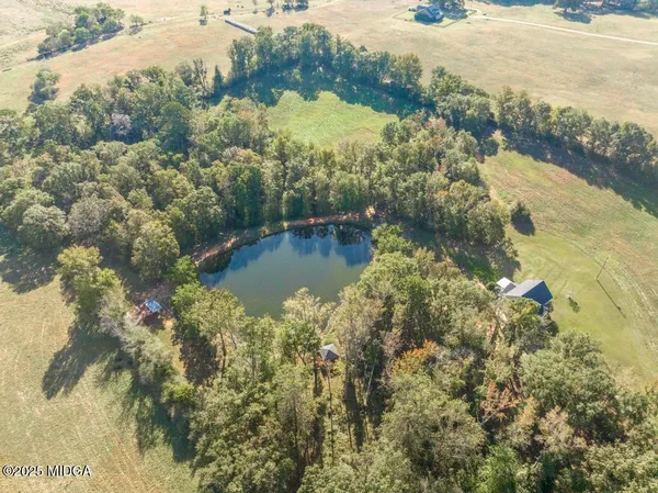 a view of a lake with a yard and mountain view