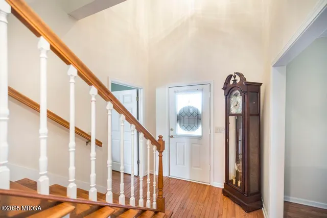 a view of an entryway with wooden floor and door
