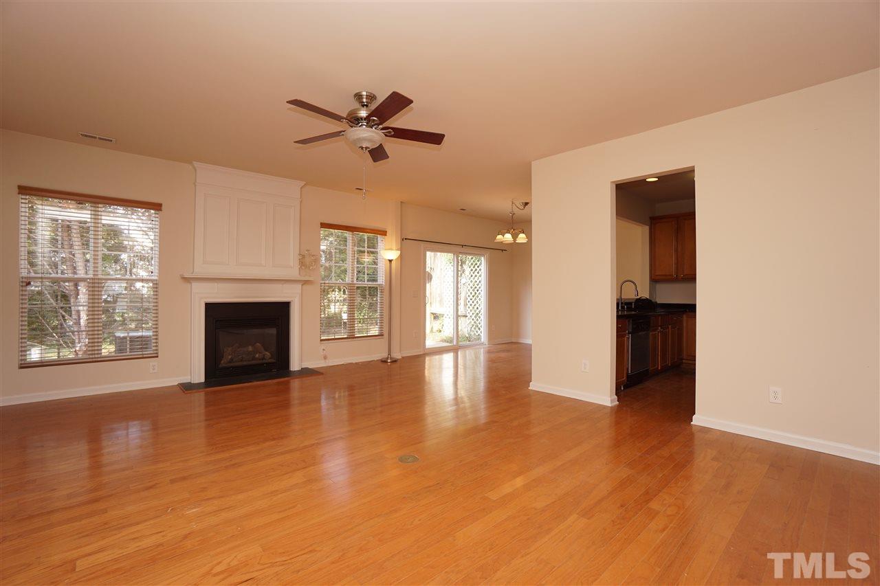 7718 Tanby Court Raleigh, NC 27613 - Photo 2 of 20 a view of a livingroom with wooden floor and a fireplace