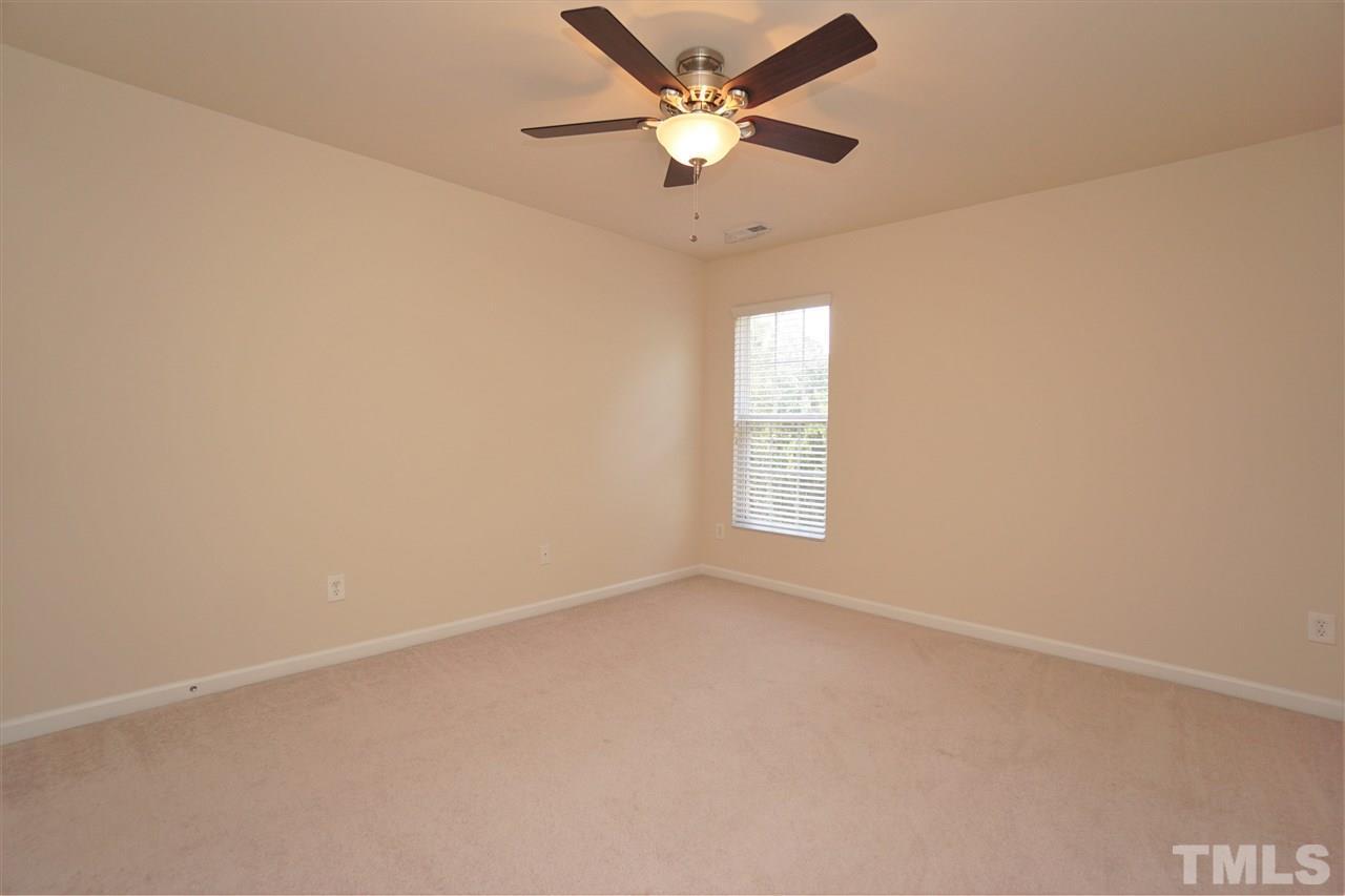 7718 Tanby Court Raleigh, NC 27613 - Photo 11 of 20 an empty room with a window and a fan