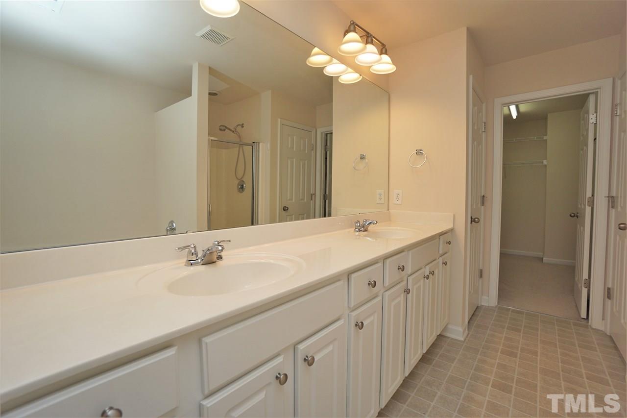 7718 Tanby Court Raleigh, NC 27613 - Photo 13 of 20 a bathroom with a double vanity sink and a mirror