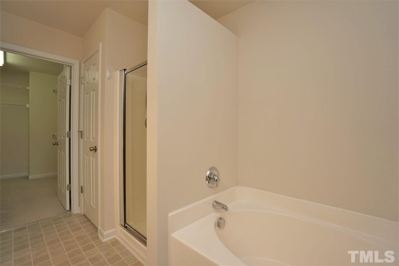 7718 Tanby Court Raleigh, NC 27613 - Photo 15 of 20 a bathroom with a bathtub