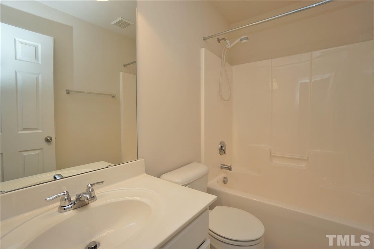 7718 Tanby Court Raleigh, NC 27613 - Photo 16 of 20 a bathroom with a sink toilet and shower