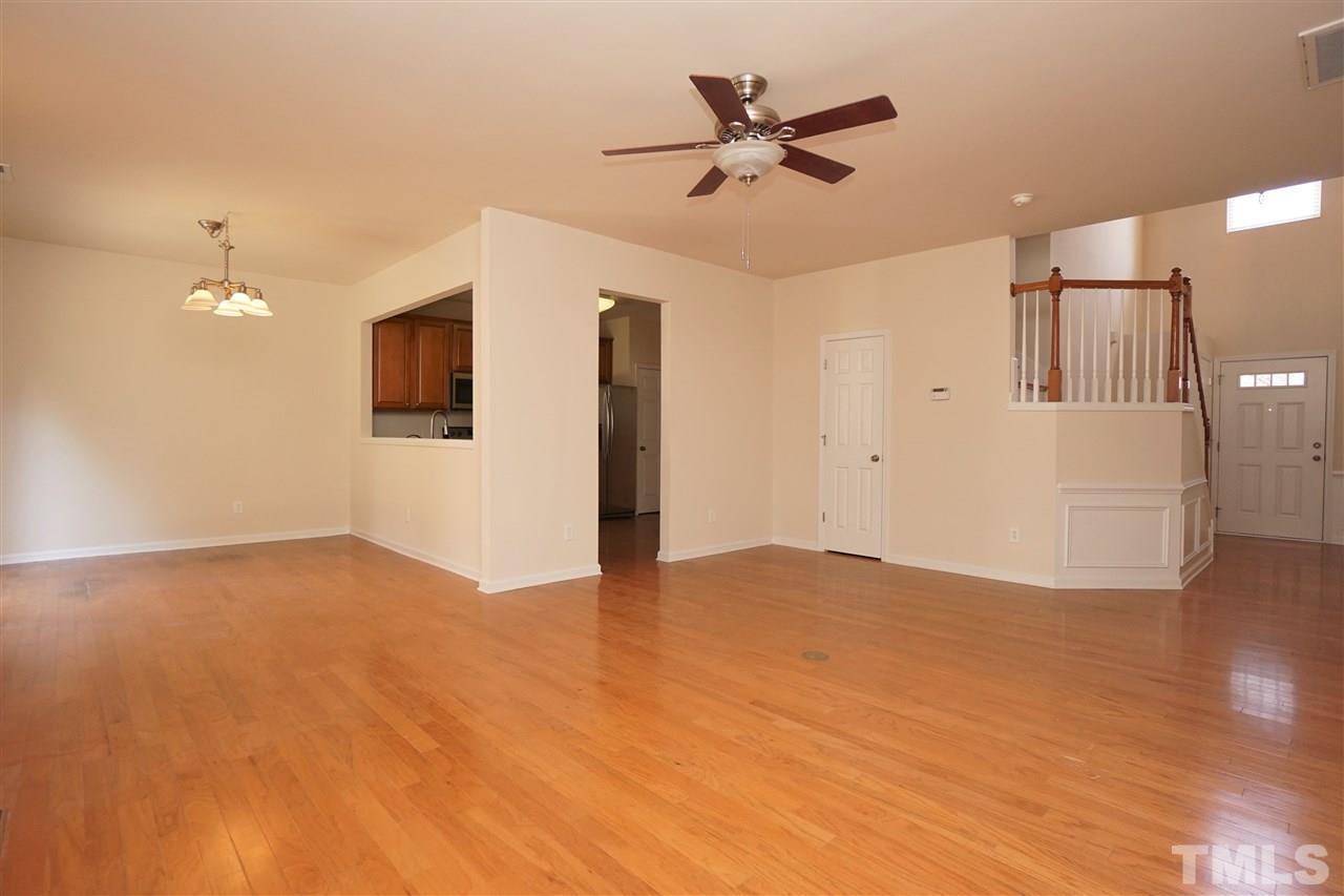 7718 Tanby Court Raleigh, NC 27613 - Photo 3 of 20 a view of empty room with wooden floor and ceiling fan