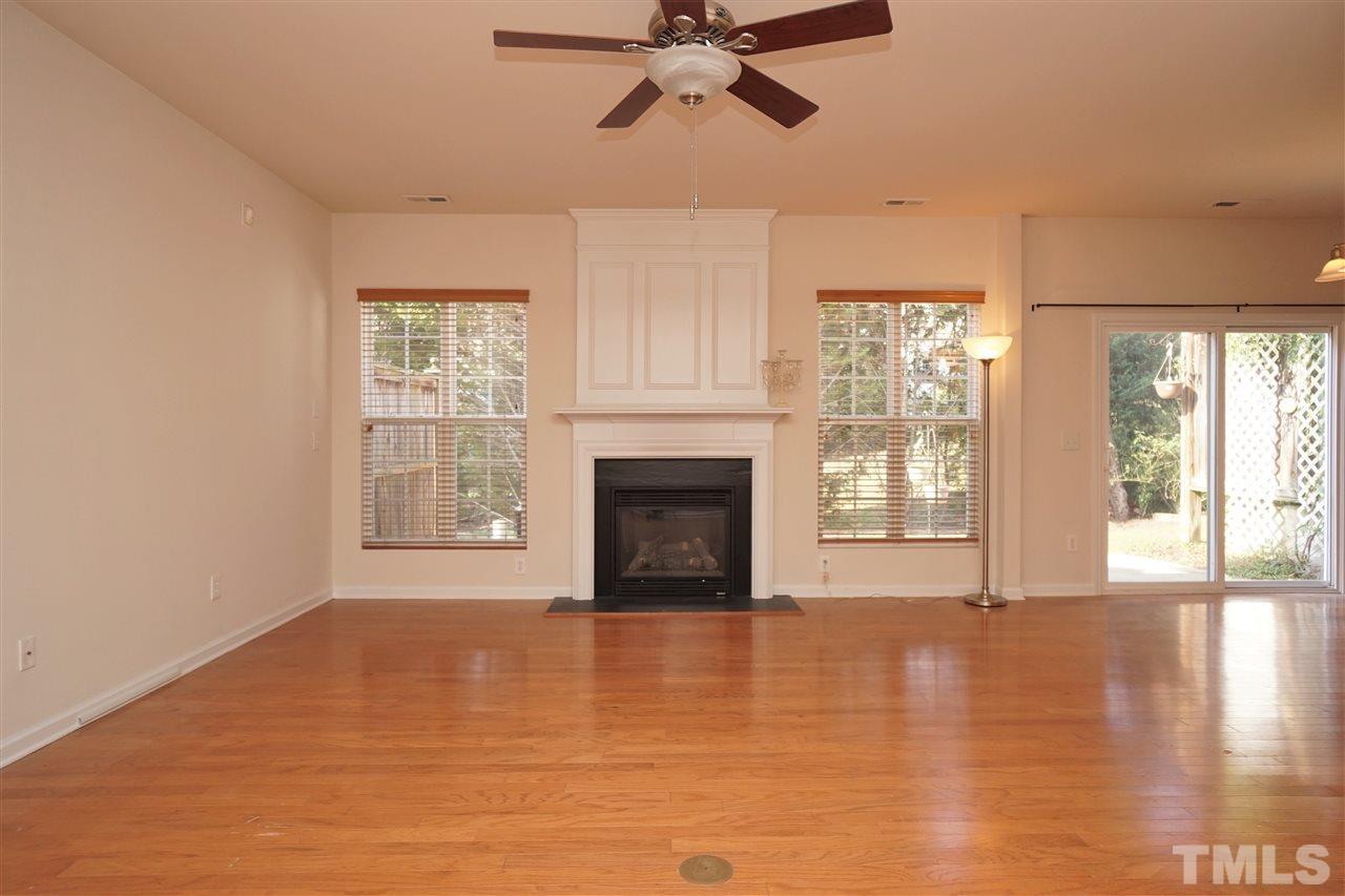 7718 Tanby Court Raleigh, NC 27613 - Photo 4 of 20 a view of an empty room with a window and wooden floor
