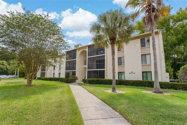 an aerial view of a house with a garden and swimming pool