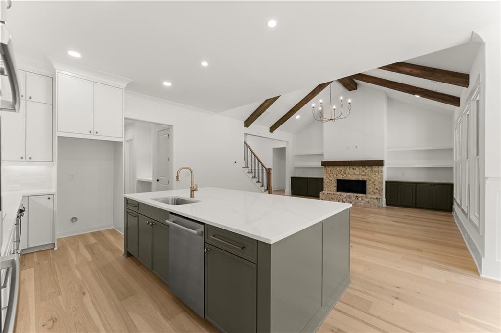 285 Reese Way Ball Ground, GA 30107 - Photo 6 of 30 a kitchen with a sink and a fireplace