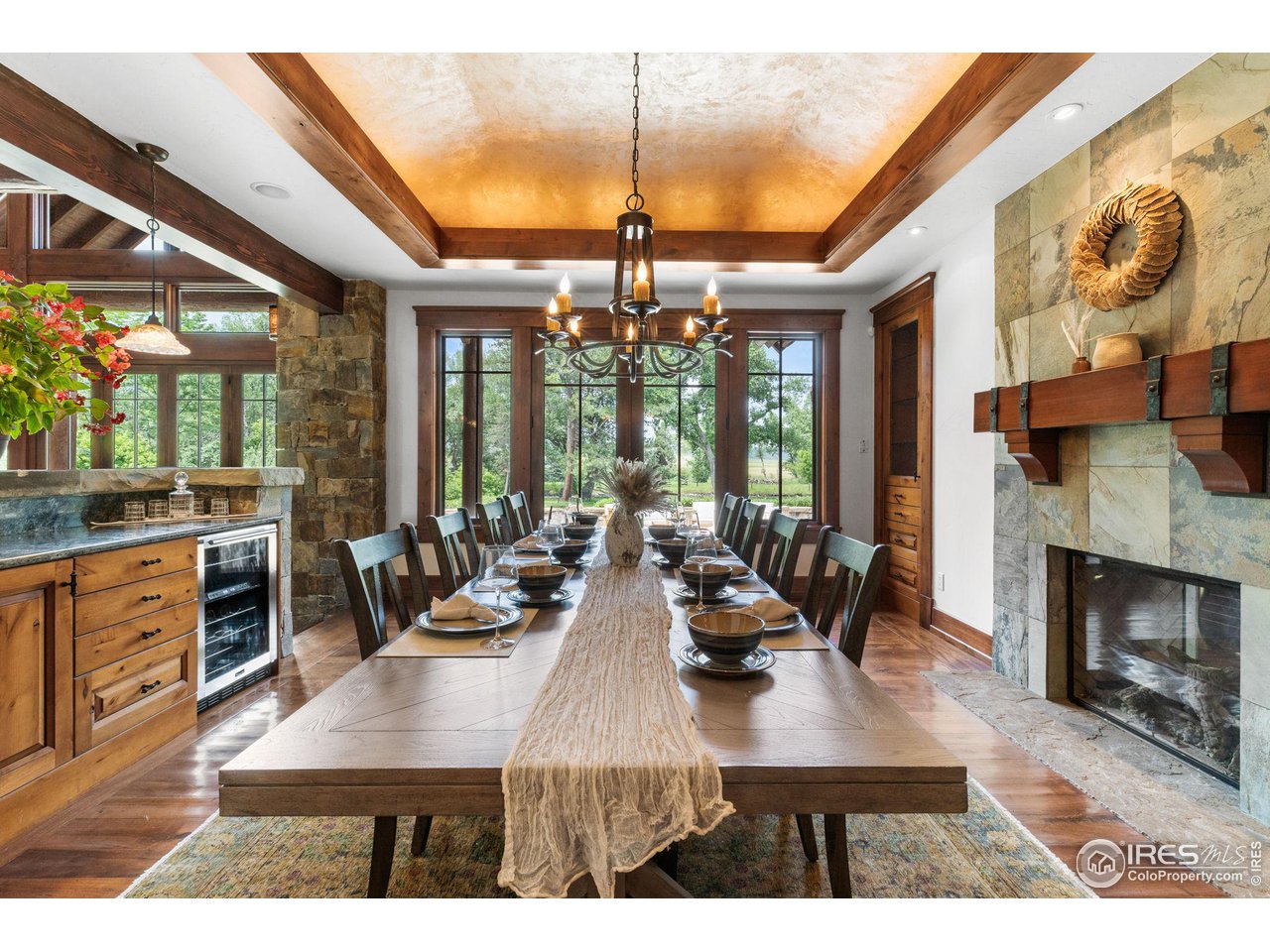 4651 Eldorado Springs Drive Boulder, CO 80303 - Photo 14 of 40 a view of a dining room and kitchen with furniture large windows and a chandelier