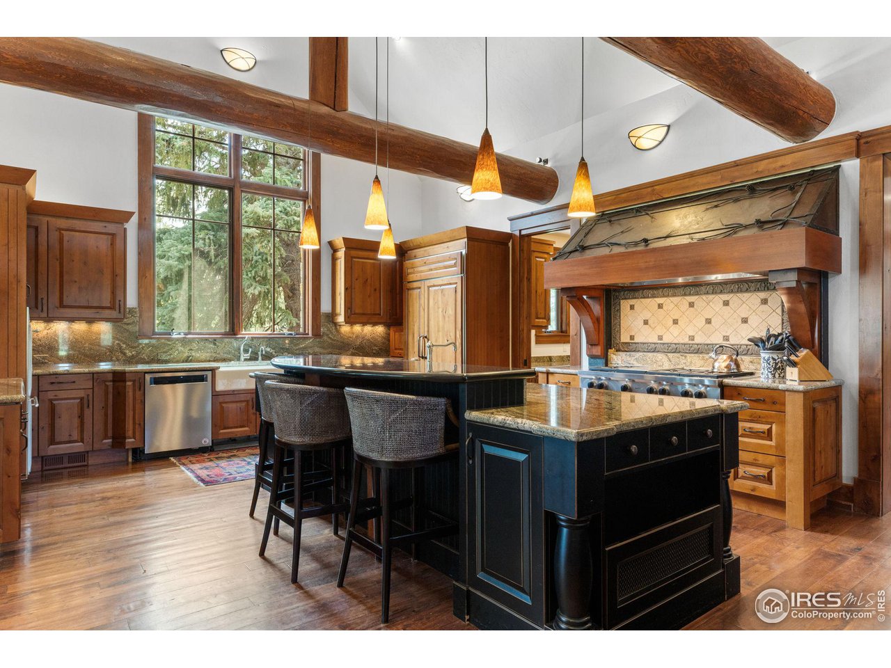 4651 Eldorado Springs Drive Boulder, CO 80303 - Photo 19 of 40 a kitchen with stainless steel appliances granite countertop a stove a sink dishwasher and cabinets with wooden floor