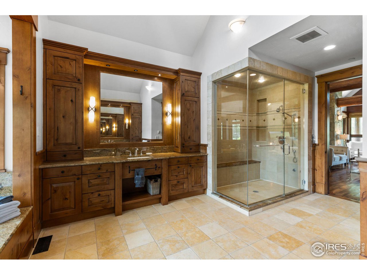 4651 Eldorado Springs Drive Boulder, CO 80303 - Photo 26 of 40 a bathroom with a granite countertop sink mirror and shower
