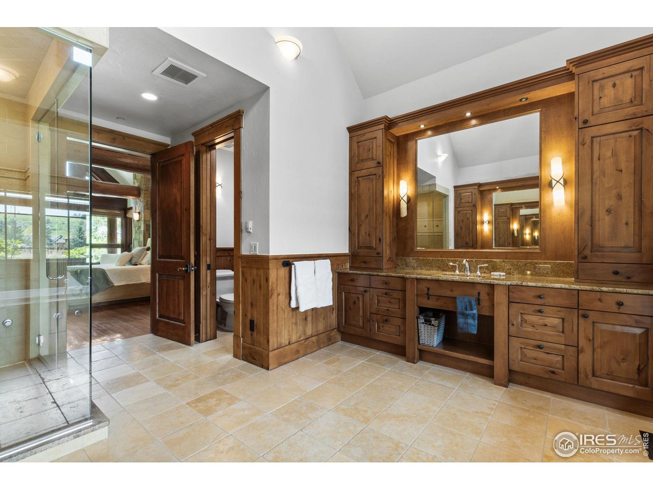 4651 Eldorado Springs Drive Boulder, CO 80303 - Photo 28 of 40 a bathroom with a sink a vanity and a large mirror