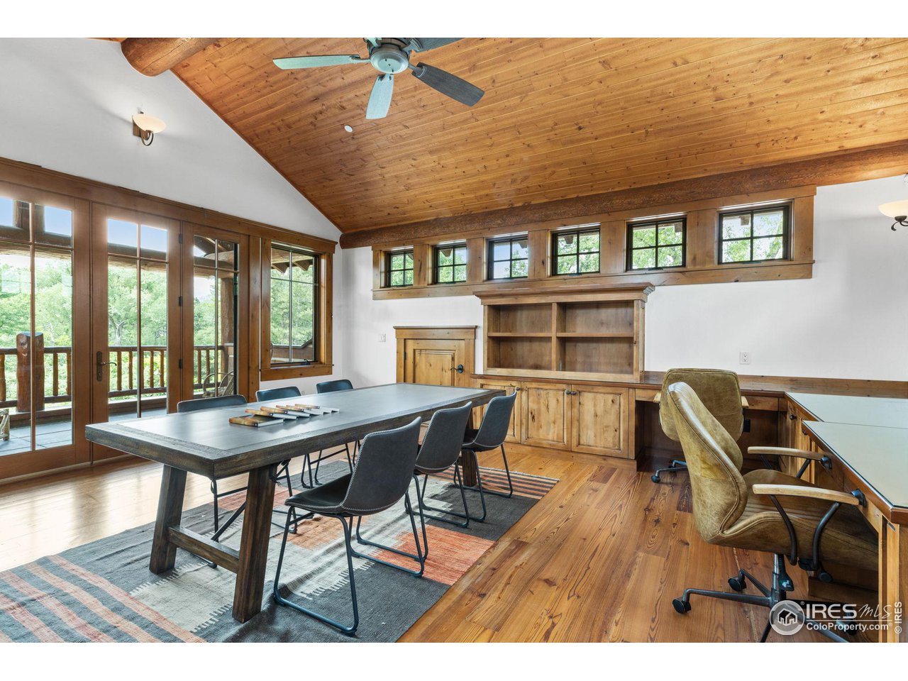 4651 Eldorado Springs Drive Boulder, CO 80303 - Photo 32 of 40 a view of a dining room with furniture and a floor to ceiling window