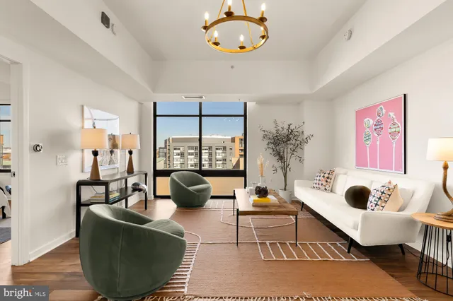 a view of a workspace with furniture and wooden floor