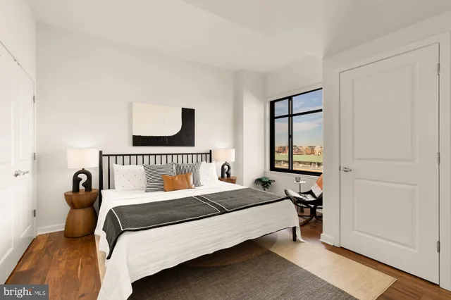 a bedroom with a bed and a window