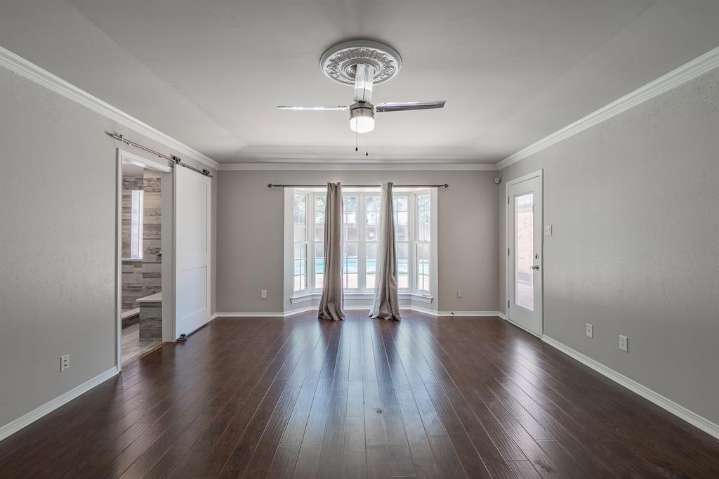 3316 Appalachian Way Plano, TX 75075 - Photo 13 of 29 an empty room with wooden floor chandelier and windows