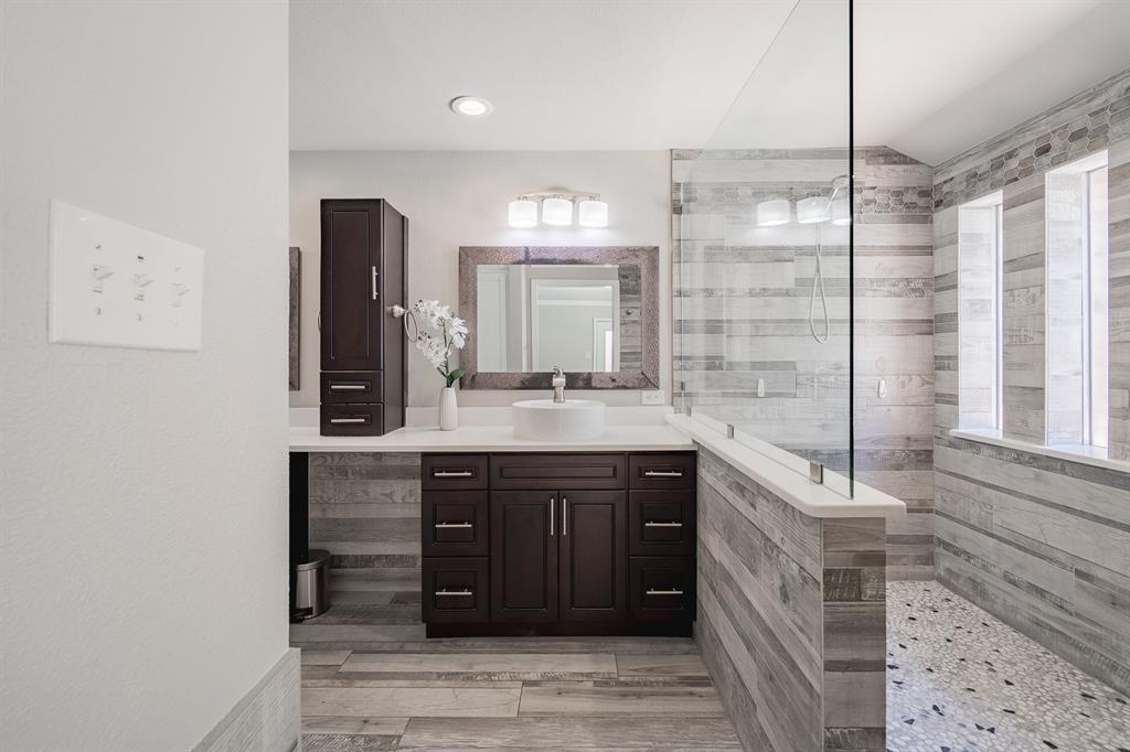 3316 Appalachian Way Plano, TX 75075 - Photo 17 of 29 a bathroom with a sink and a mirror