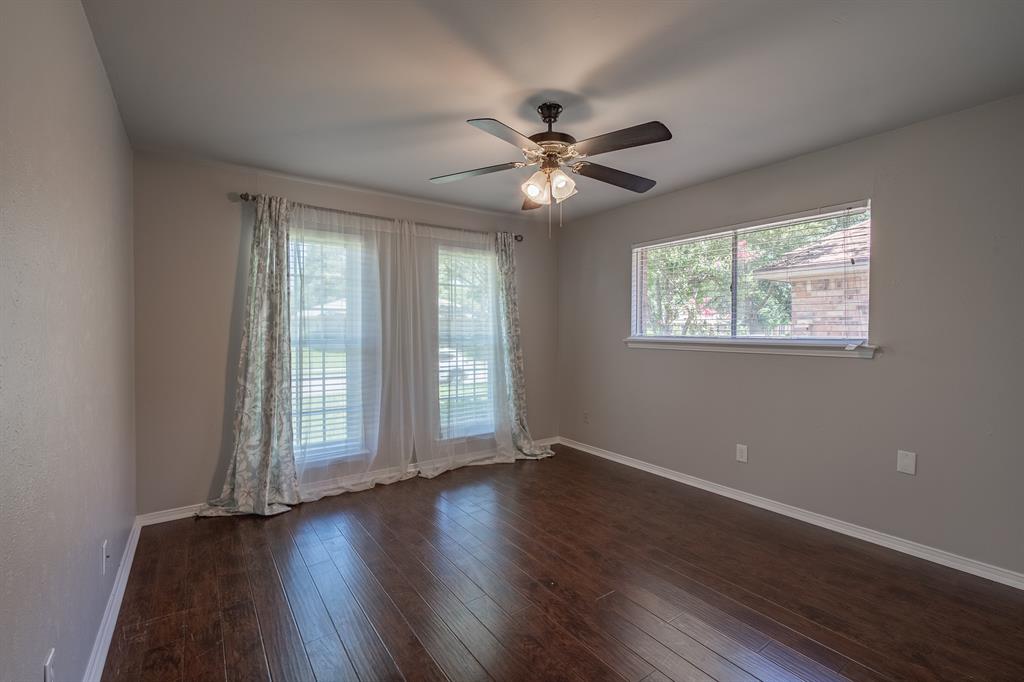 3316 Appalachian Way Plano, TX 75075 - Photo 19 of 29 a view of an empty room with wooden floor and a window