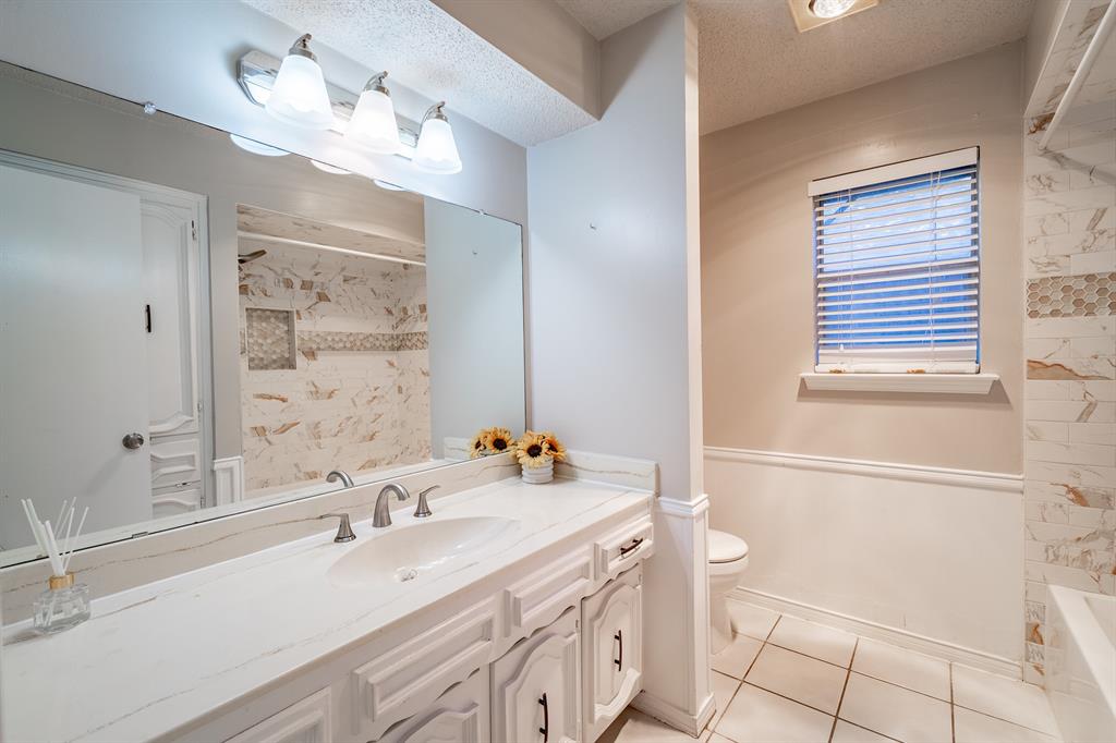 3316 Appalachian Way Plano, TX 75075 - Photo 21 of 29 a bathroom with a sink a toilet a mirror and shower