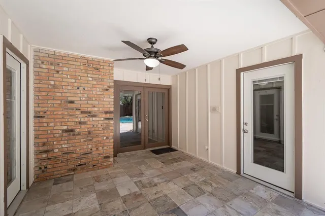a view of a hallway with a chandelier fan