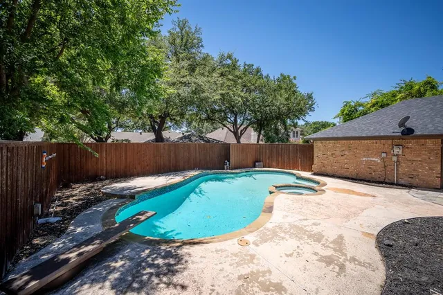 a view of a backyard with wooden fence